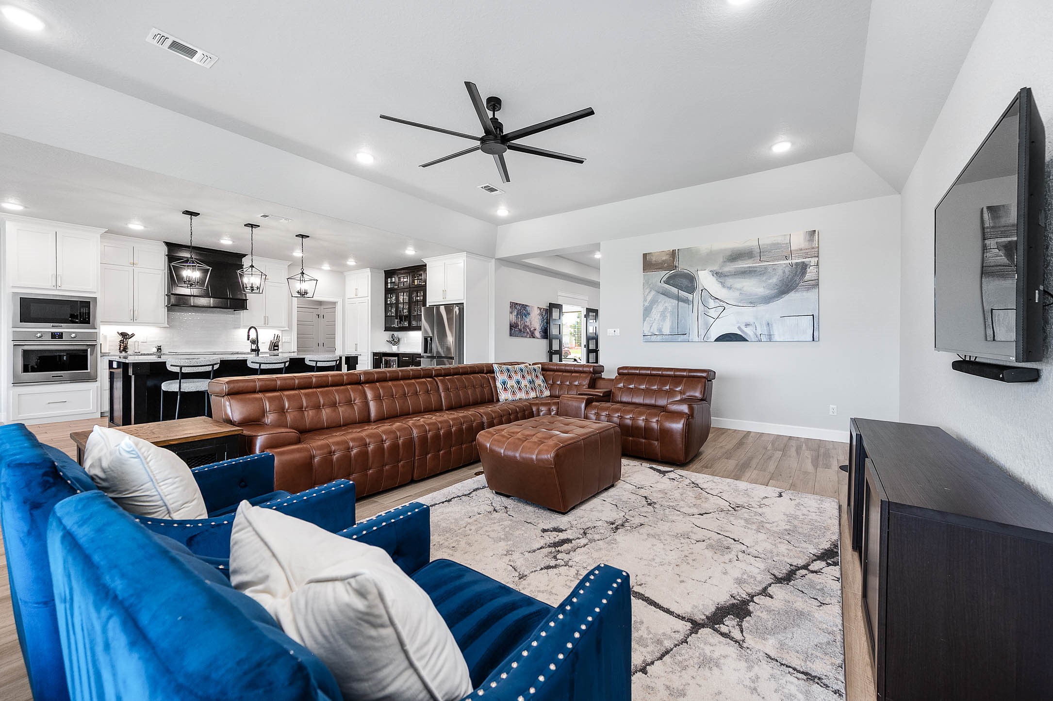 800 Greystone Lane Angleton, TX 77515 - Photo 12 of 49 a living room with furniture kitchen area and a chandelier