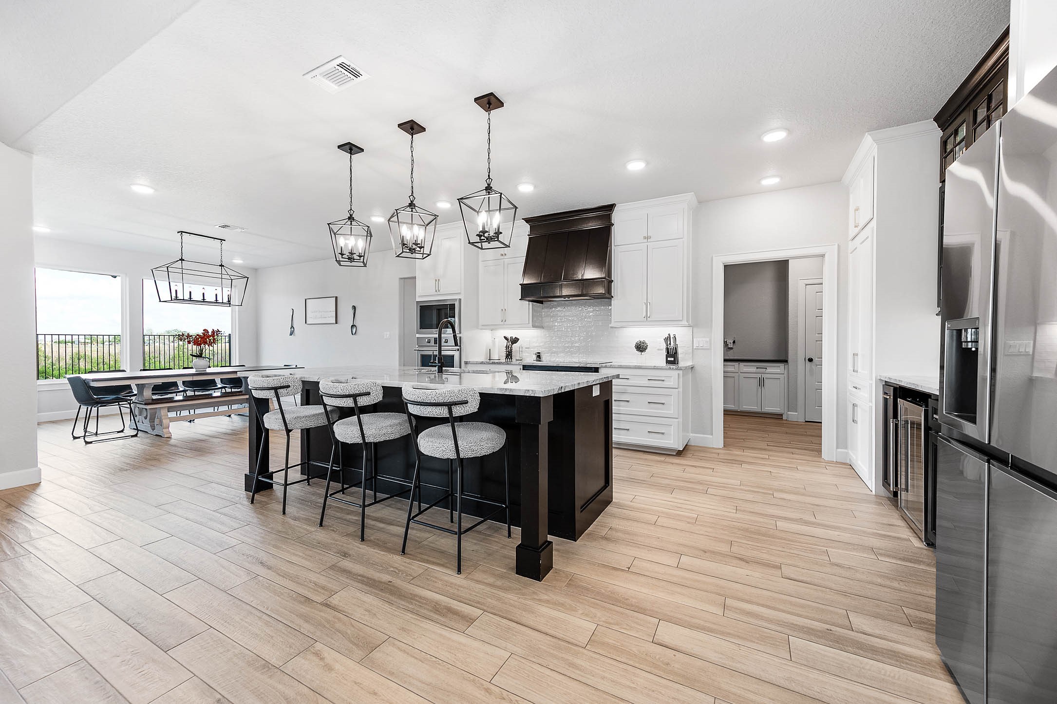 800 Greystone Lane Angleton, TX 77515 - Photo 13 of 49 a large kitchen with a table and chairs