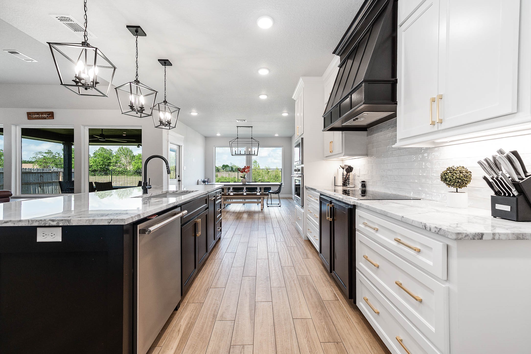 800 Greystone Lane Angleton, TX 77515 - Photo 17 of 49 a kitchen with stainless steel appliances granite countertop lots of counter top space and wooden floor