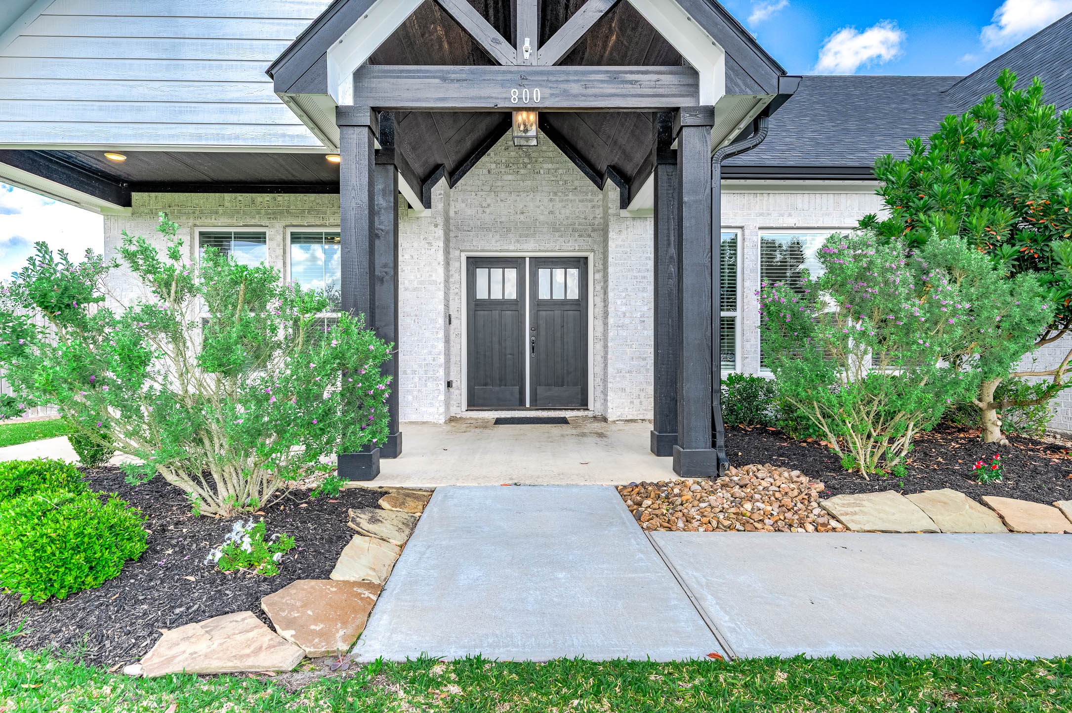 800 Greystone Lane Angleton, TX 77515 - Photo 2 of 49 a front view of a house with garden