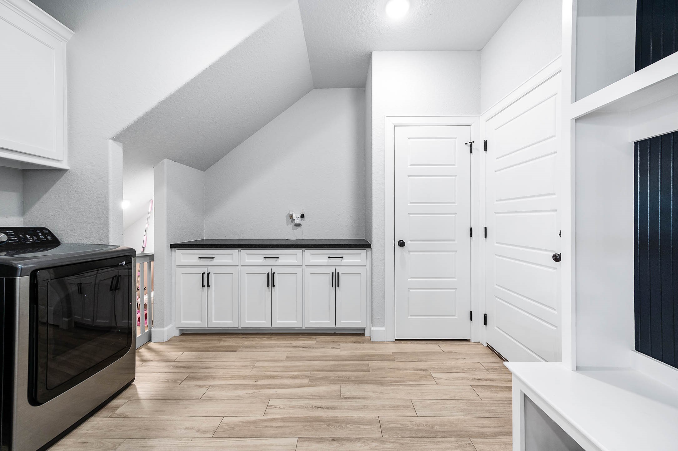800 Greystone Lane Angleton, TX 77515 - Photo 28 of 49 a view of a kitchen with white cabinets and wooden floor