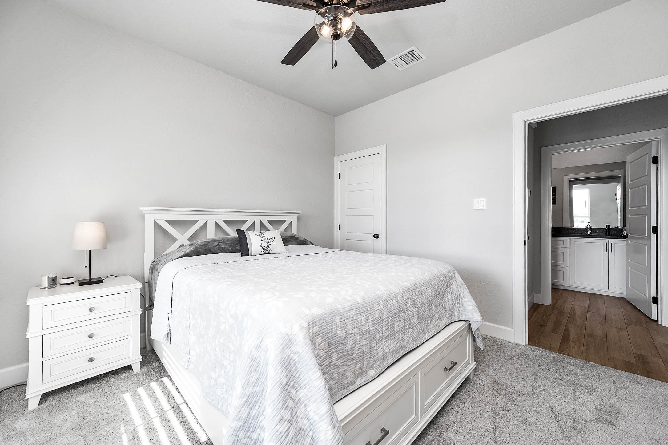 800 Greystone Lane Angleton, TX 77515 - Photo 32 of 49 a bedroom with a bed and a chandelier