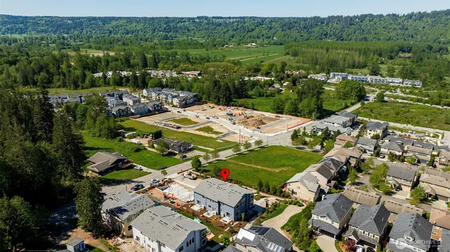 an aerial view of a house with a garden and lake view