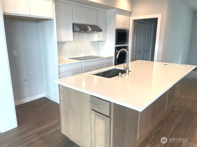 a room with wooden floor and large windows