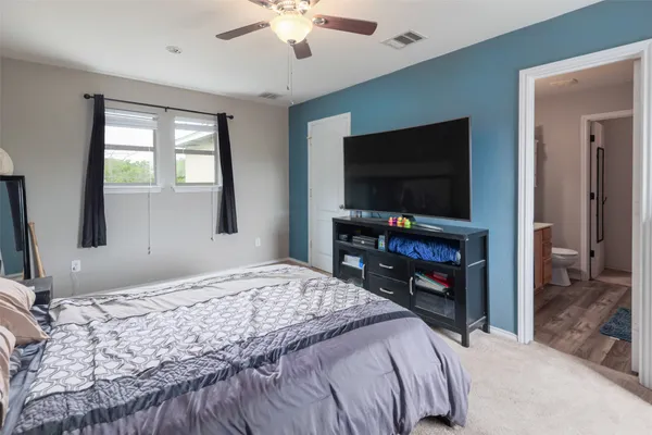 a bedroom with a bed and a flat screen tv