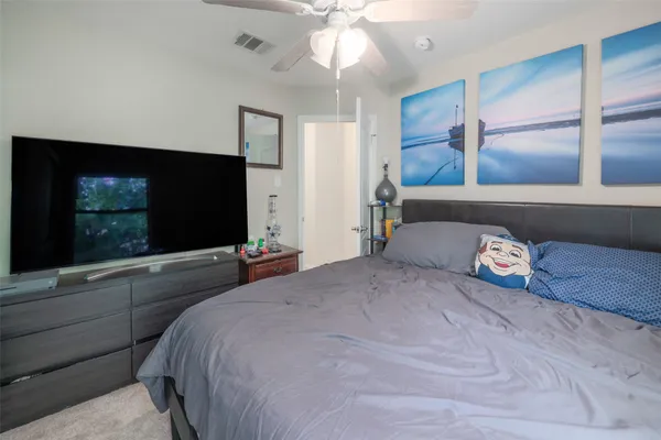 a bedroom with a bed and a flat screen tv