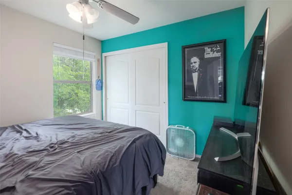 a bedroom with a bed and a chair