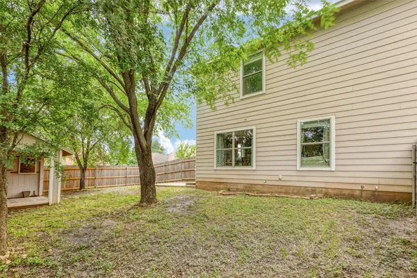 a view of house with backyard