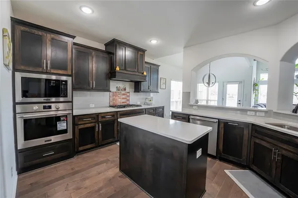 a kitchen with stainless steel appliances granite countertop a sink stove and oven