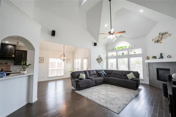 a living room with furniture a chandelier and a flat screen tv
