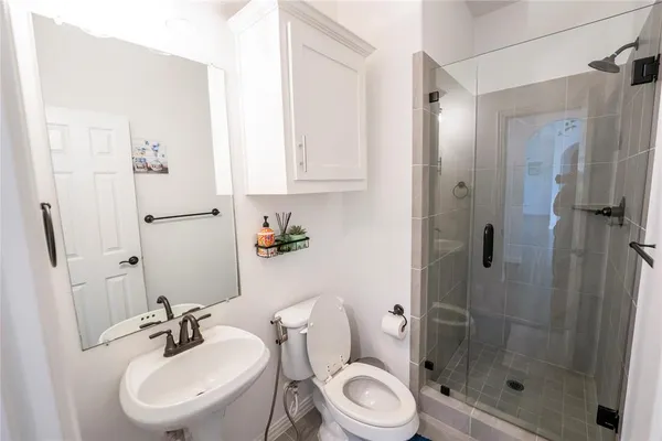 a bathroom with a sink toilet and shower