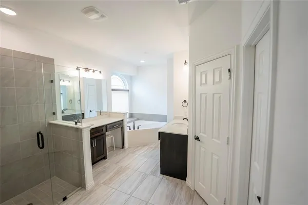 a large bathroom with a double vanity sink and a mirror