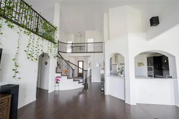 a view of entryway and hall with wooden floor