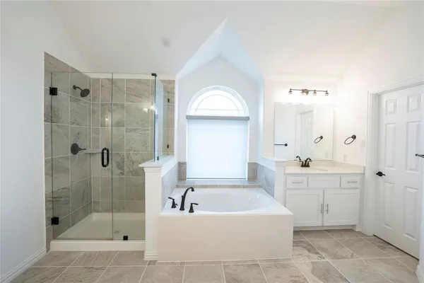 a bathroom with a bathtub shower sink and mirror