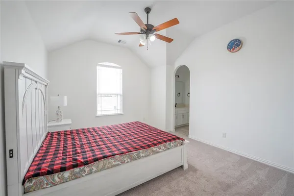 a bedroom with a bed and window