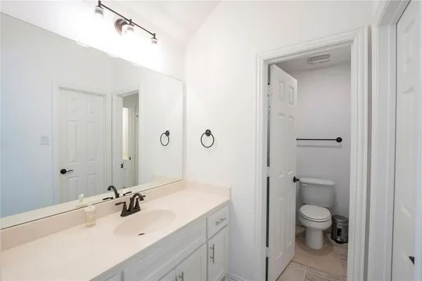 a bathroom with a sin toilet sink shower and mirror