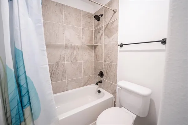 a bathroom with a toilet and a bathtub