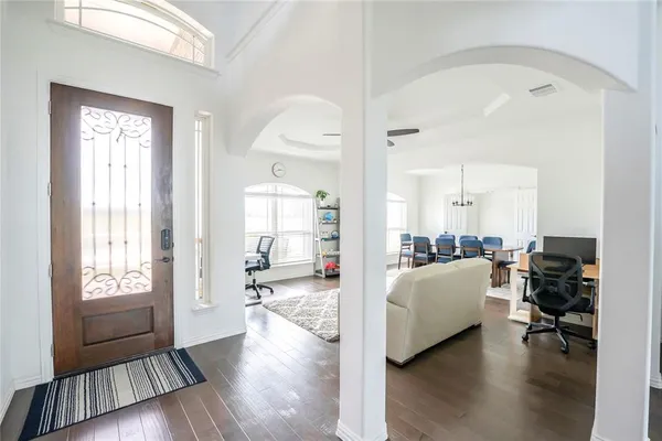 a living room with furniture and a wooden floor
