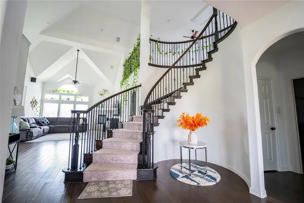 a view of entryway and hall with wooden floor