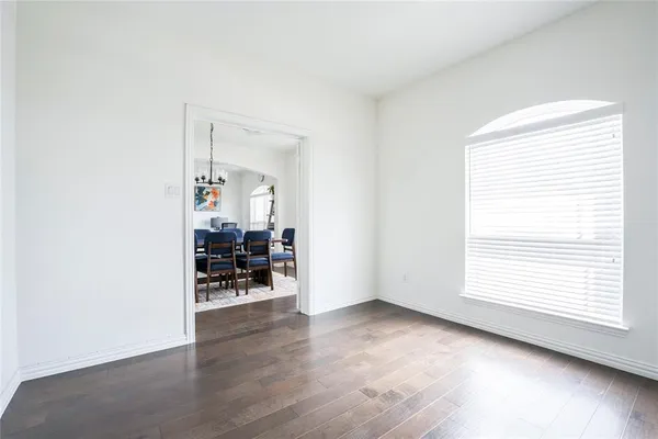 an empty room with furniture and a window
