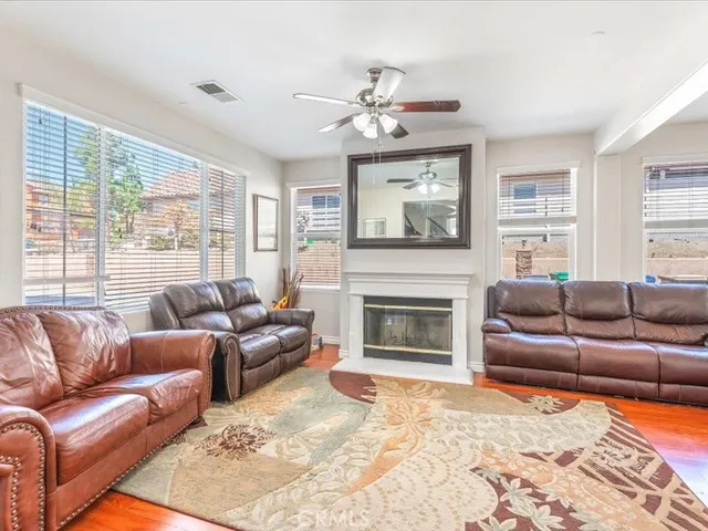 a living room with furniture a large window and a fireplace