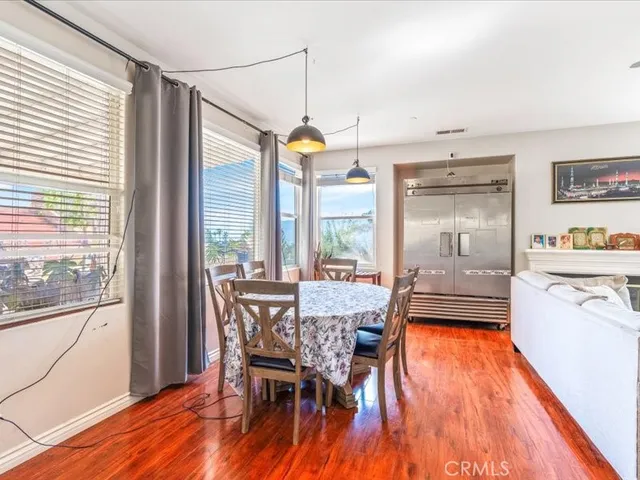 a dining room with furniture a chandelier and wooden floor