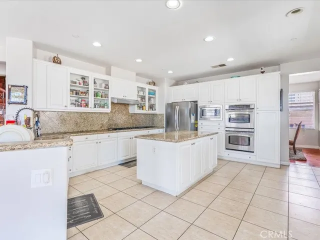 a kitchen with stainless steel appliances granite countertop a sink and cabinets