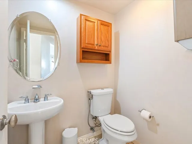 a bathroom with a toilet sink and mirror