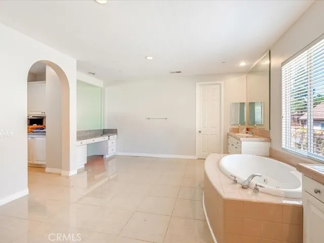 a spacious bathroom with a bathtub and a sink