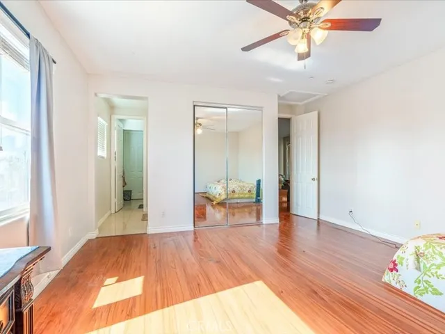 a view of a livingroom with wooden floor and a ceiling fan