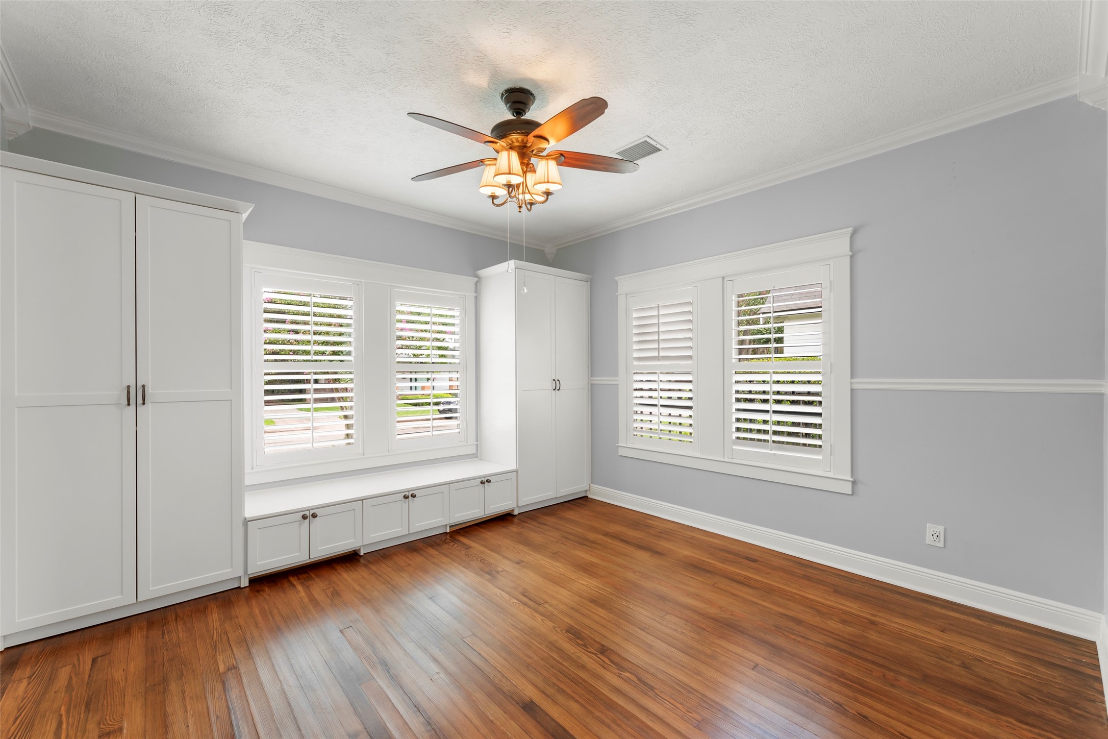 1120 Winston Street Houston, TX 77009 - Photo 25 of 35 The sun-drenched second bedroom doubles as a bright retreat, featuring a sleek built-in closet that offers integrated storage without sacrificing the room's airy, open feel.