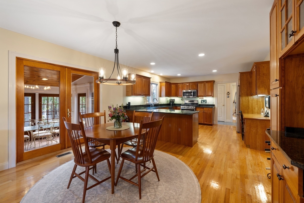 2 Marlboro Road Lexington, MA 02421 - Photo 6 of 36 a dining room with stainless steel appliances kitchen island granite countertop a table and chairs