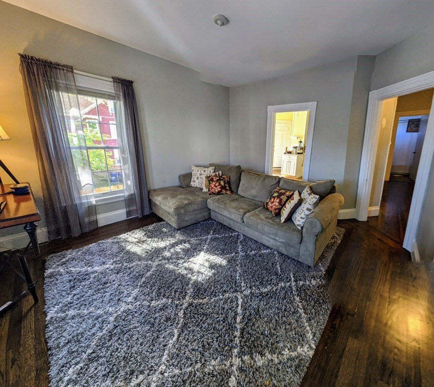 74 Sydney Street, Unit 2 Boston, MA 02125 - Photo 2 of 28 a living room with furniture and a flat screen tv