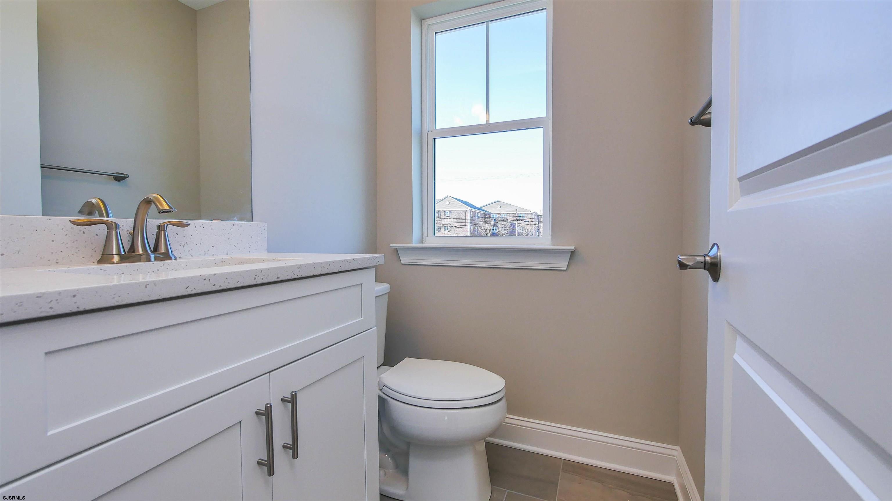 539 Sunset Avenue Somers Point, NJ 08244 - Photo 12 of 34 a bathroom with a sink a toilet and a window
