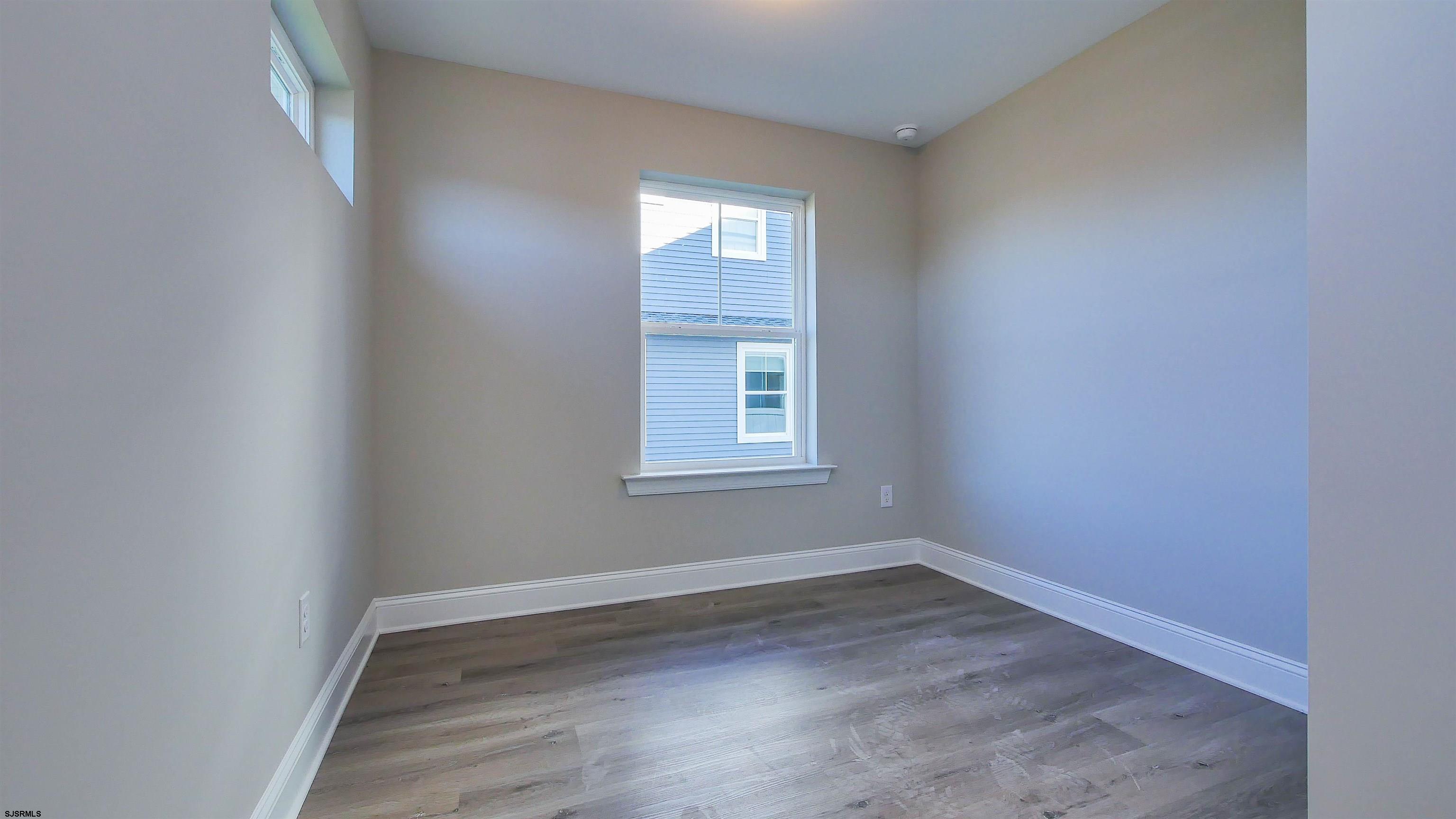 539 Sunset Avenue Somers Point, NJ 08244 - Photo 13 of 34 an empty room with wooden floor and windows
