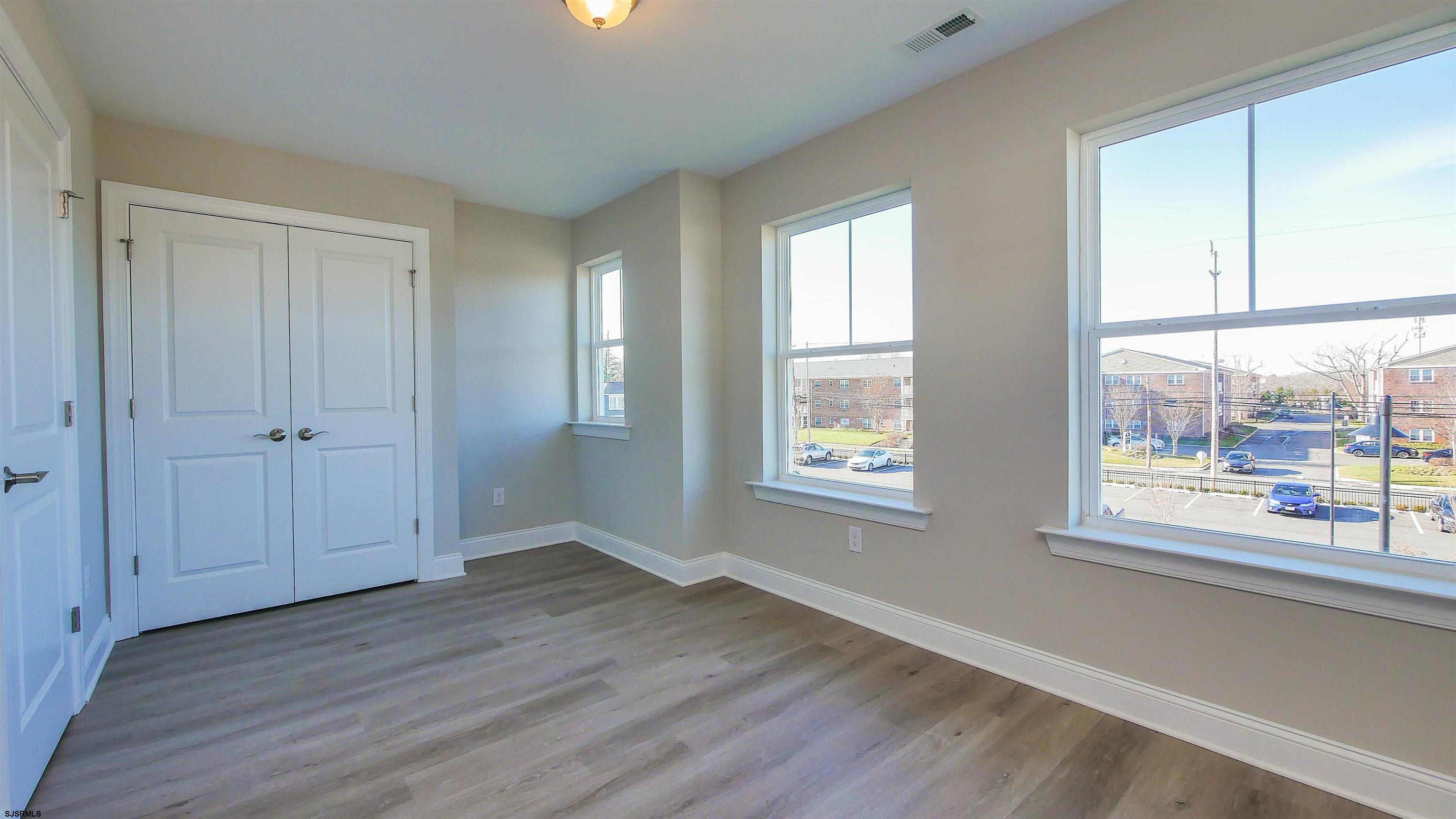 539 Sunset Avenue Somers Point, NJ 08244 - Photo 17 of 34 a view of an empty room with wooden floor and a window