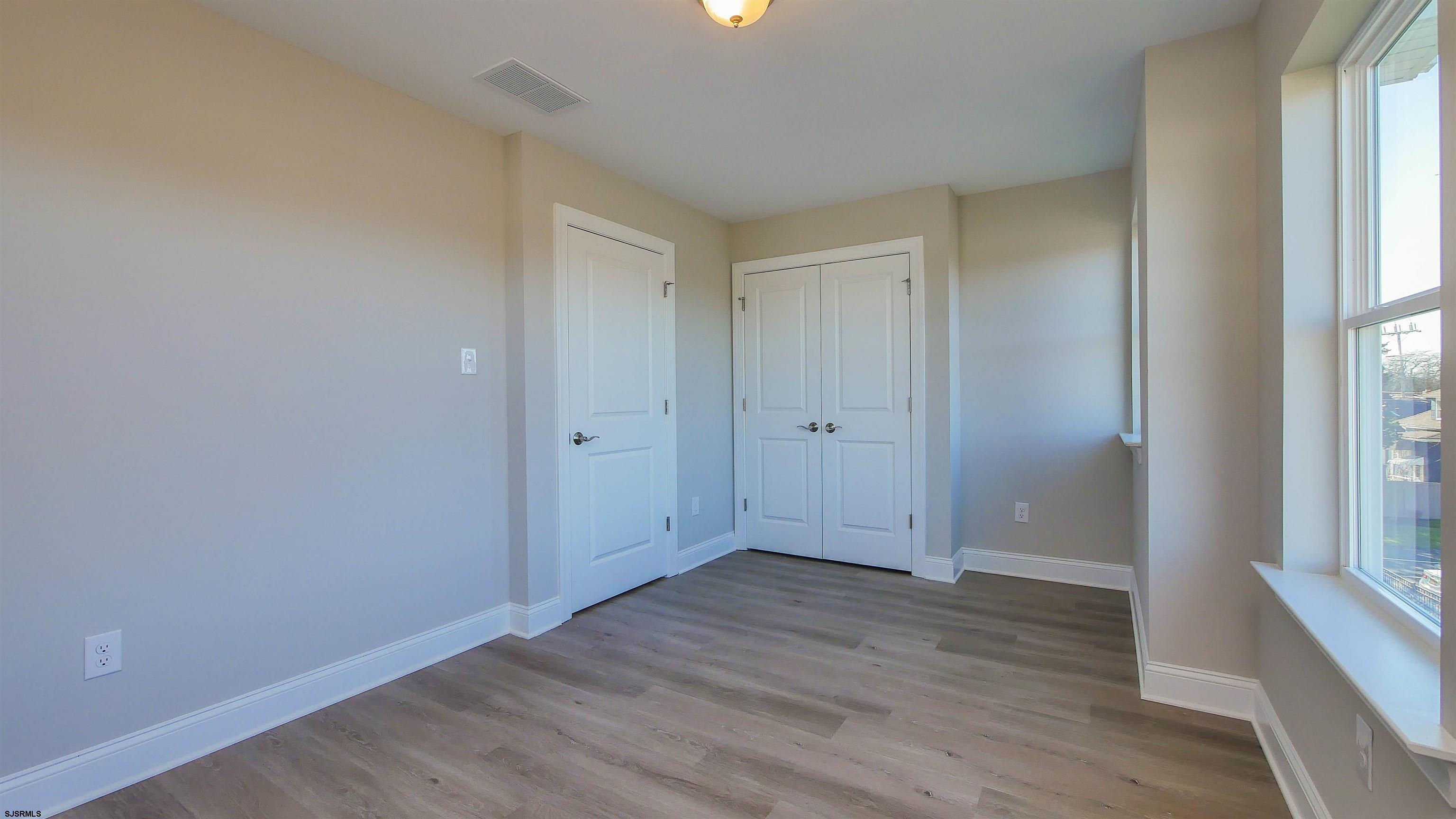 539 Sunset Avenue Somers Point, NJ 08244 - Photo 18 of 34 an empty room with wooden floor and windows