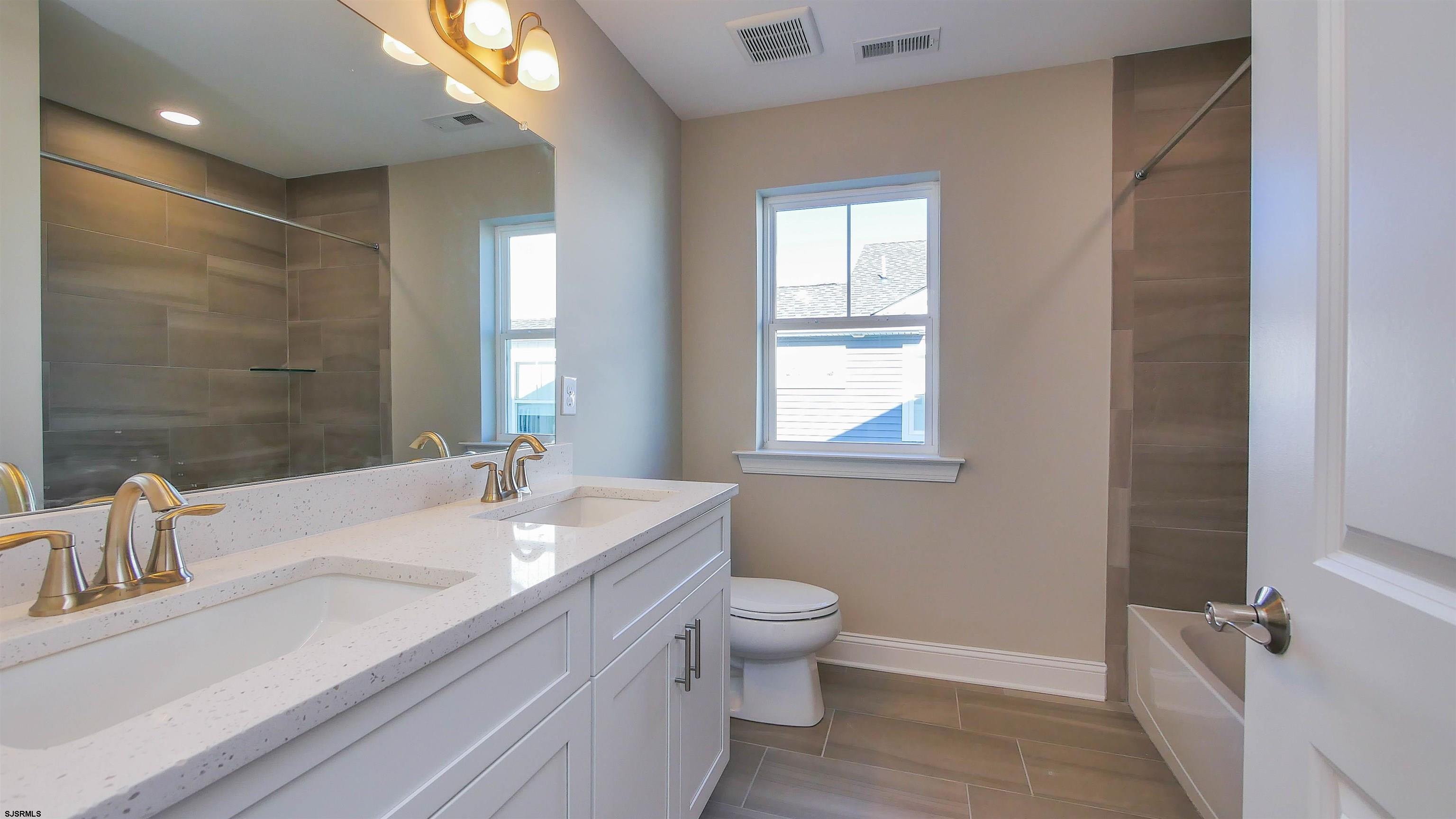 539 Sunset Avenue Somers Point, NJ 08244 - Photo 19 of 34 a bathroom with a double vanity sink toilet and a mirror