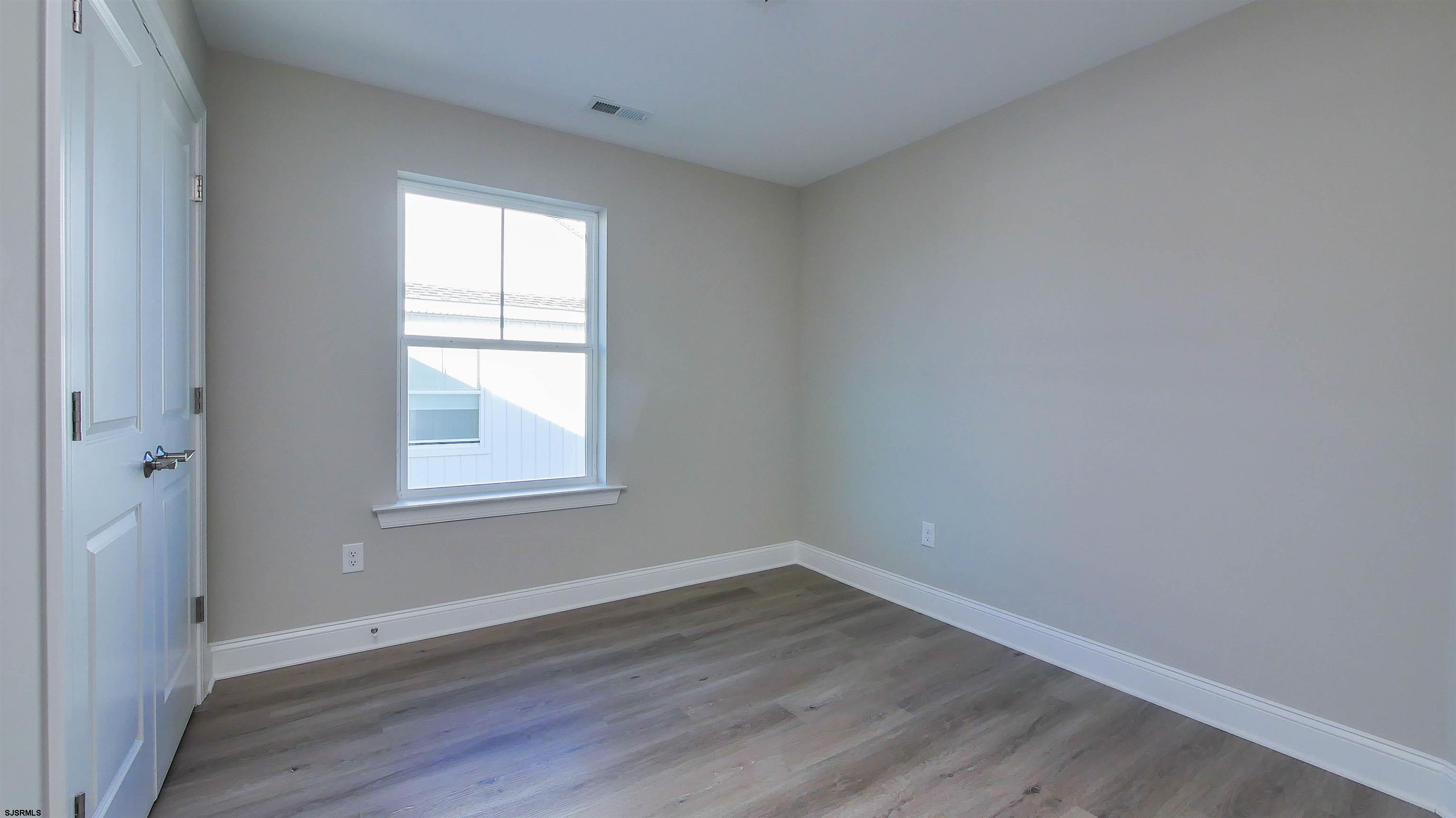 539 Sunset Avenue Somers Point, NJ 08244 - Photo 21 of 34 an empty room with wooden floor and windows