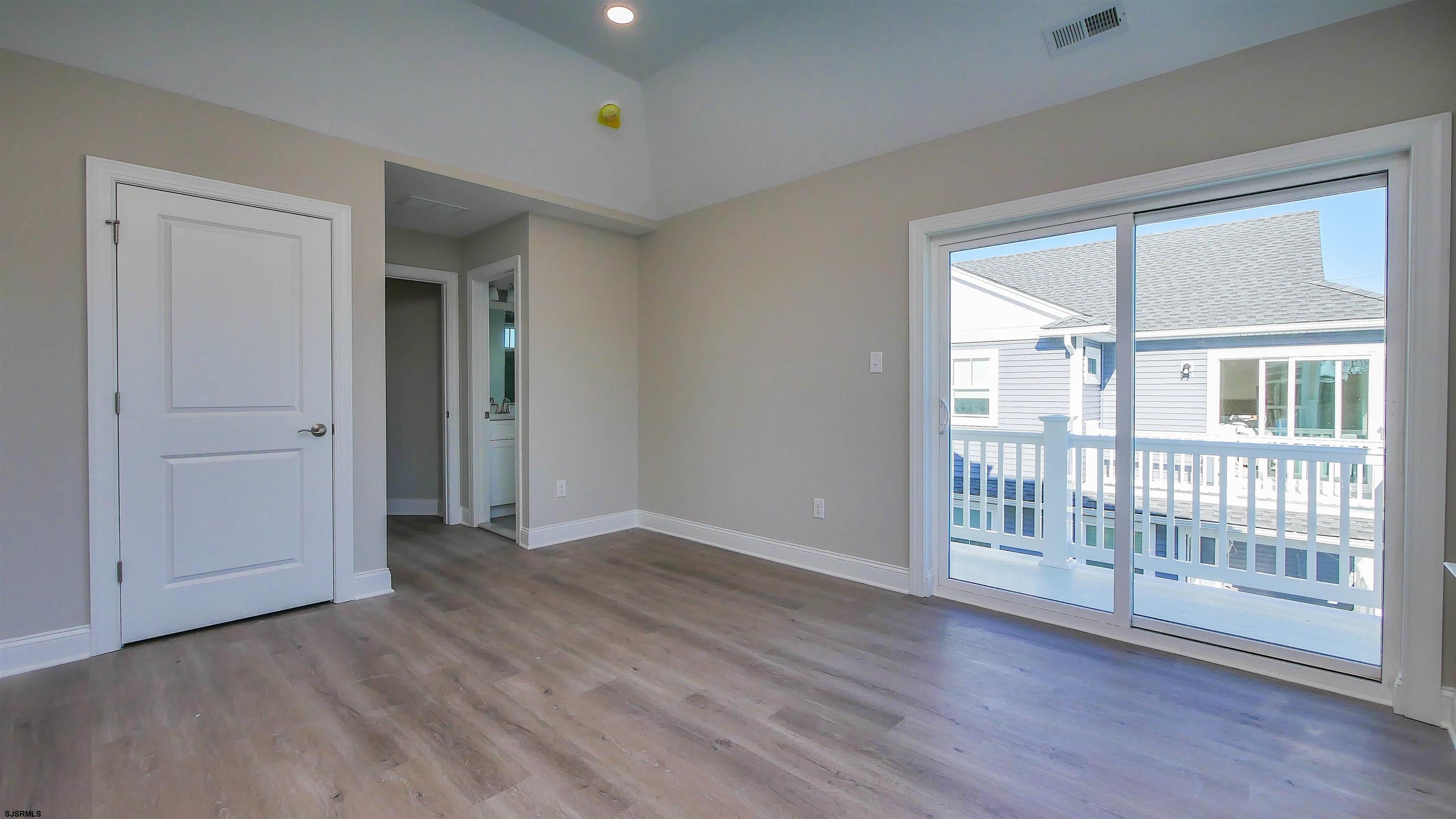 539 Sunset Avenue Somers Point, NJ 08244 - Photo 24 of 34 an empty room with wooden floor and windows