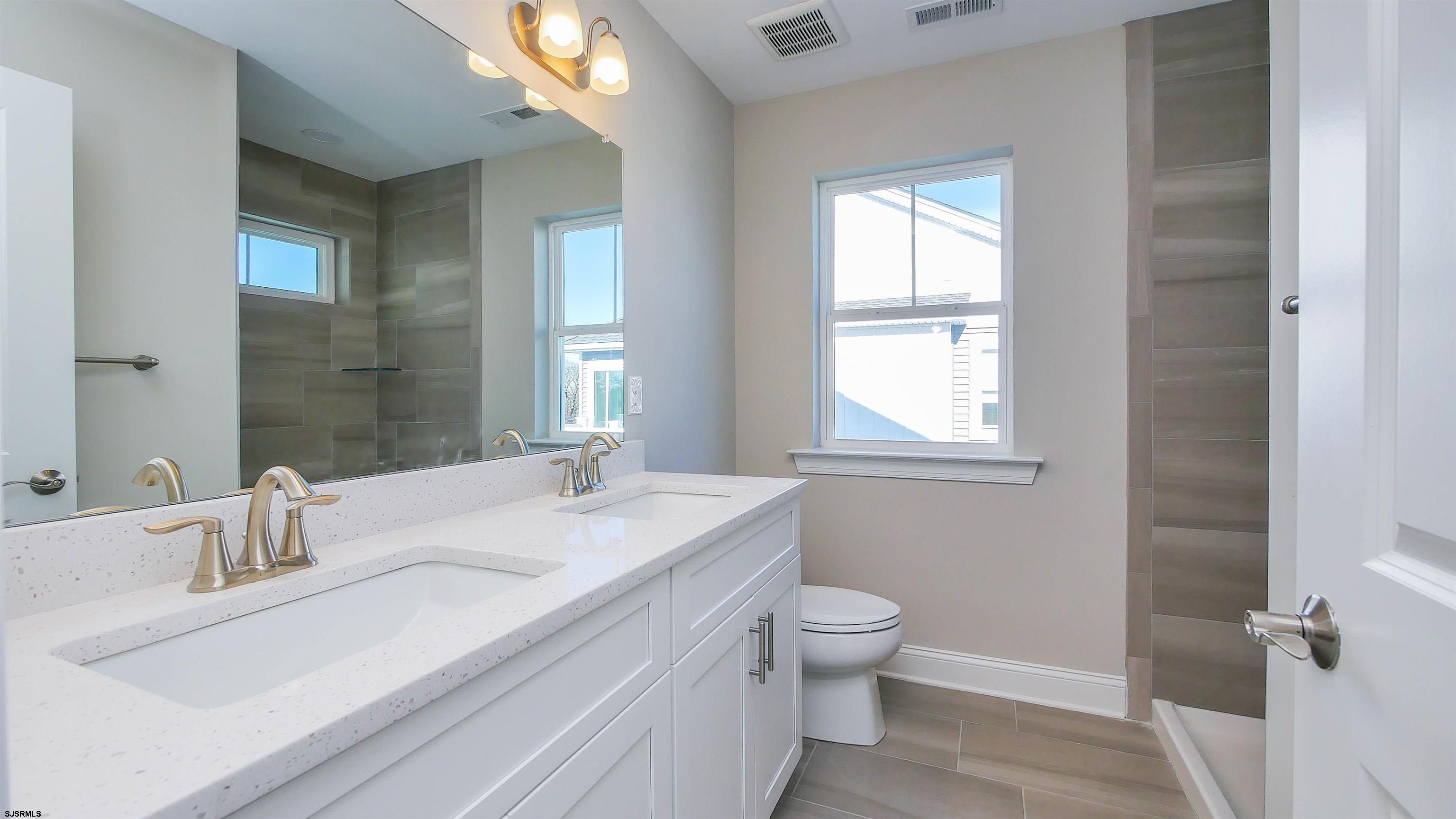 539 Sunset Avenue Somers Point, NJ 08244 - Photo 26 of 34 a bathroom with a granite countertop sink toilet and mirror