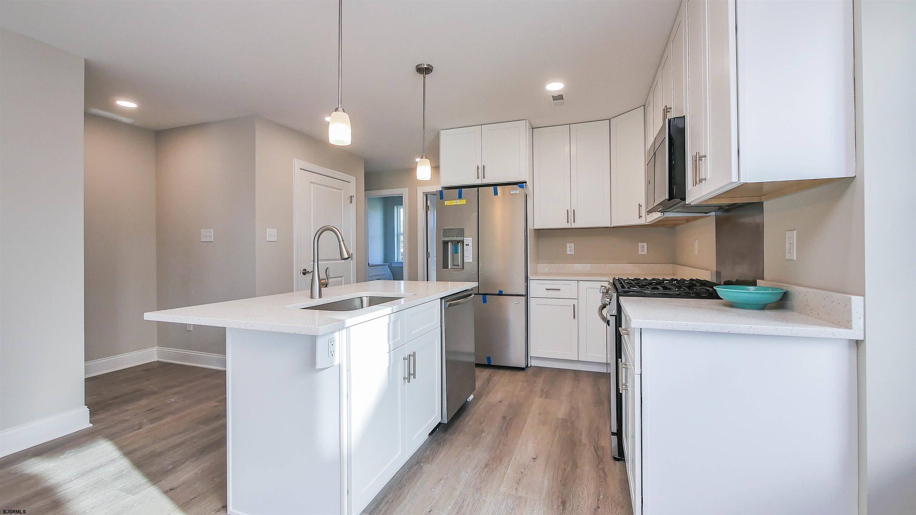 539 Sunset Avenue Somers Point, NJ 08244 - Photo 7 of 34 a kitchen with kitchen island a sink stainless steel appliances and cabinets