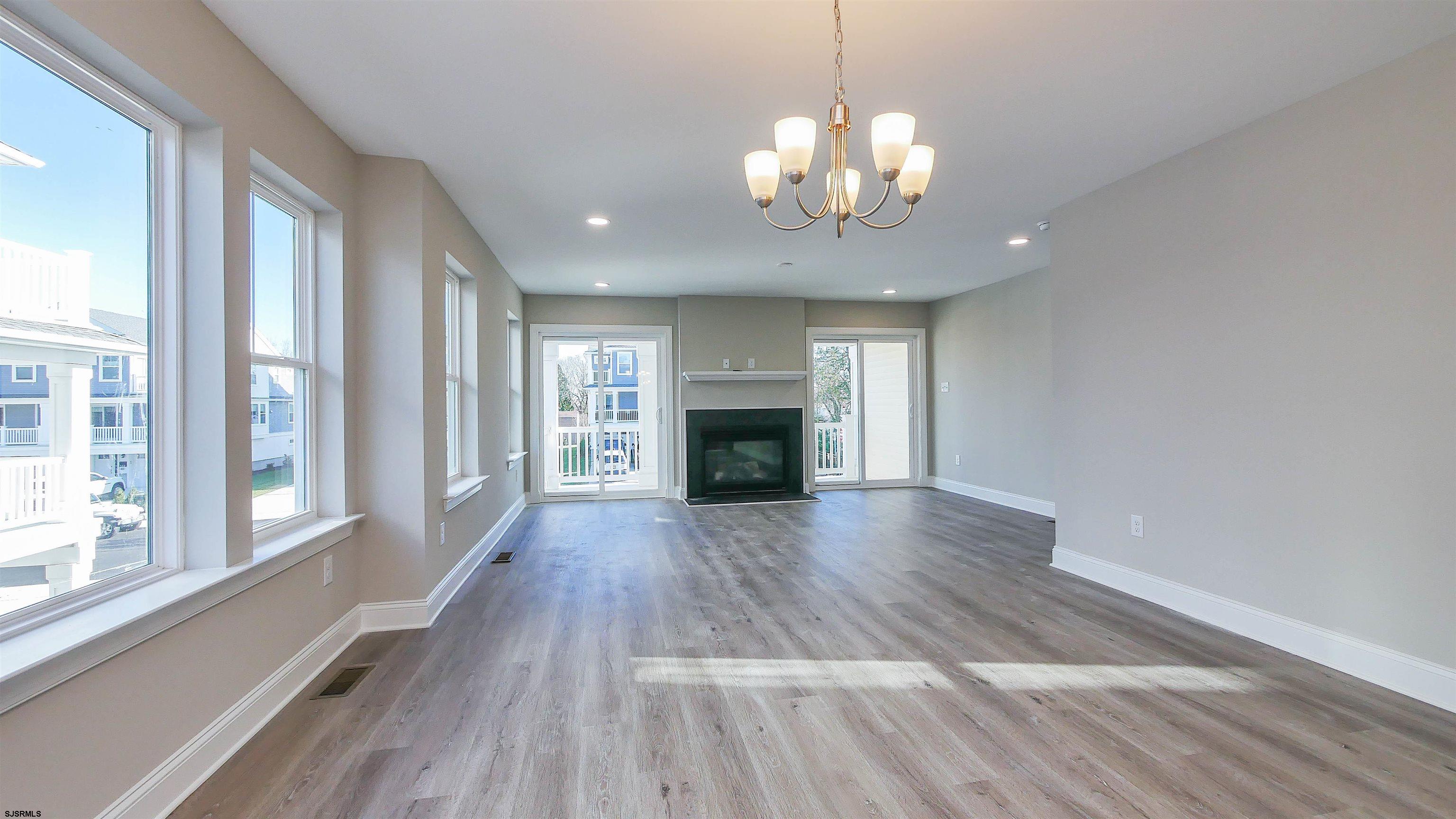 539 Sunset Avenue Somers Point, NJ 08244 - Photo 8 of 34 a view of a livingroom with a fireplace wooden floor and chandelier