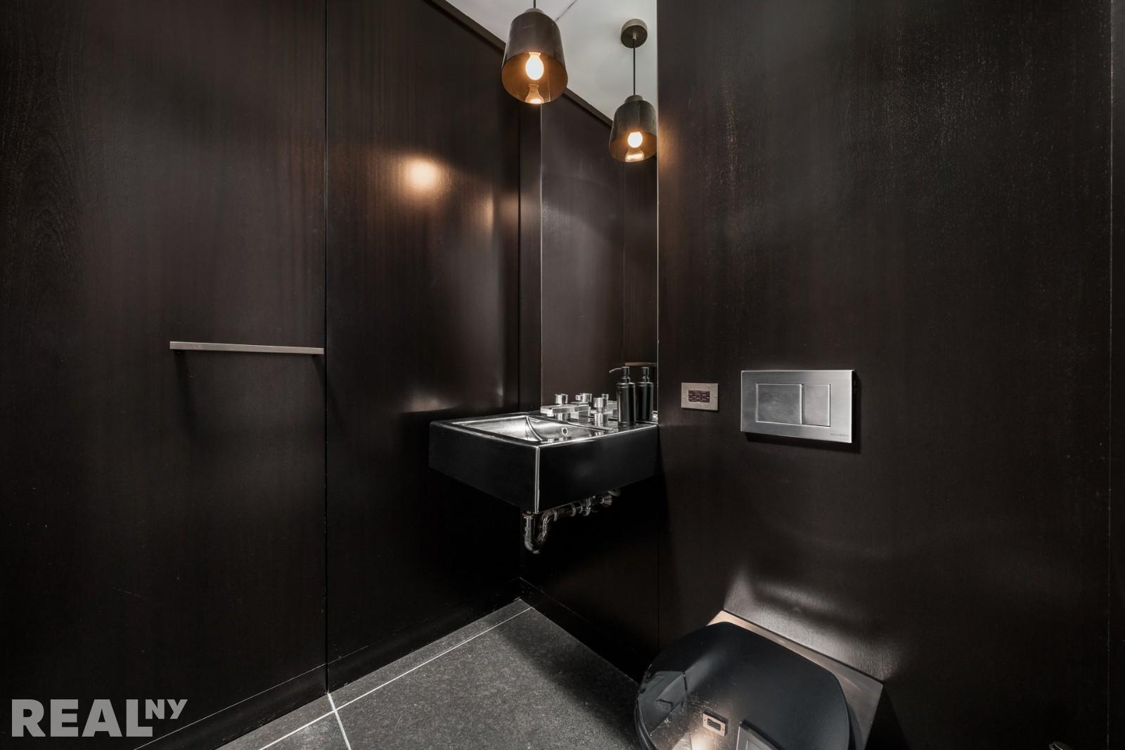 15 Union Square West, Unit 7C Manhattan, NY 10003 - Photo 11 of 18 a bathroom with a sink and mirror