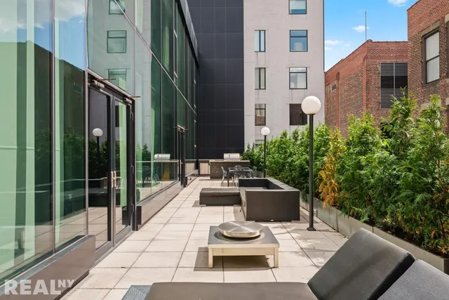 a view of a patio with couches table and chairs and potted plants