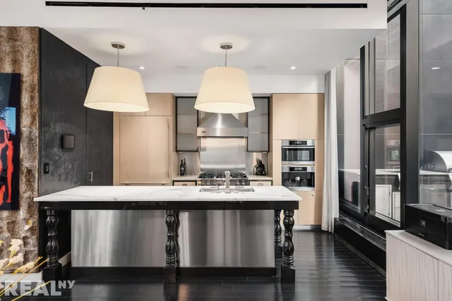 a kitchen with a table chairs refrigerator and a sink