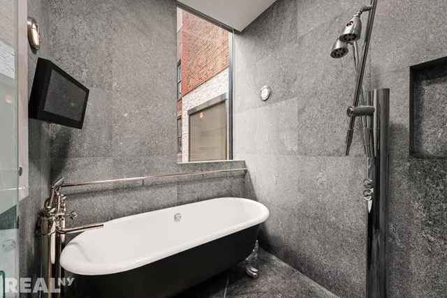 a bathroom with a sink a toilet a mirror and shower
