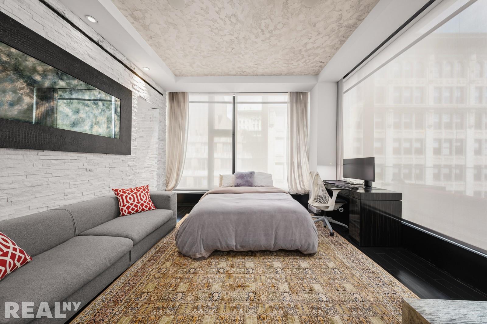 15 Union Square West, Unit 7C Manhattan, NY 10003 - Photo 9 of 18 a bedroom with a bed couch and window