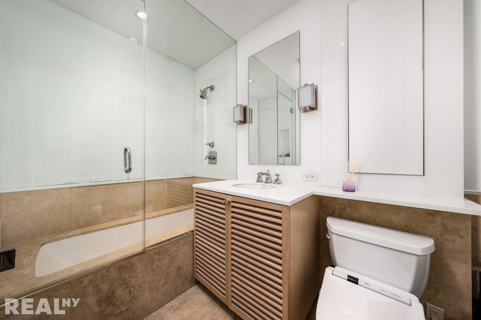 15 Union Square West, Unit 7C Manhattan, NY 10003 - Photo 10 of 18 a bathroom with a sink a toilet and a mirror