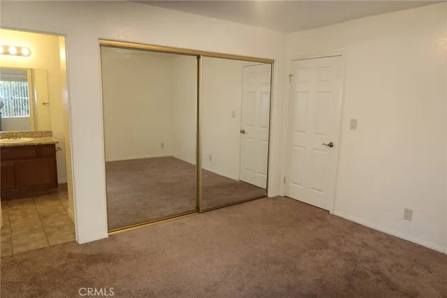 a view of a hallway with wooden floor and entryway